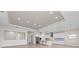 Spacious open-concept living area featuring a modern kitchen with stainless steel appliances and ample counter space for cooking at 10309 Longmeadow Ave, Parrish, FL 34219