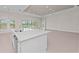 Open kitchen area featuring a center island with a sink, stainless steel appliances, and sliding glass doors that overlook the pool area at 10309 Longmeadow Ave, Parrish, FL 34219