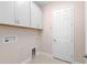 This laundry room has overhead storage and utility hookups at 10309 Longmeadow Ave, Parrish, FL 34219