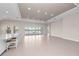 Expansive living room features recessed lighting, tile flooring, and sliding glass doors to the lanai at 10309 Longmeadow Ave, Parrish, FL 34219