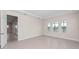 Spacious living room with tile flooring, base molding and a view of the water through the large windows at 10309 Longmeadow Ave, Parrish, FL 34219
