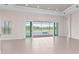 Bright living room featuring sliding glass doors that open to the screened pool area, allowing for seamless indoor-outdoor living at 10309 Longmeadow Ave, Parrish, FL 34219