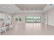 Spacious living room with a tray ceiling, tile floors, and large sliding glass doors offering great views at 10309 Longmeadow Ave, Parrish, FL 34219
