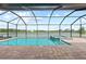 Serene lake view from the pool and spa located in the screened-in lanai with brick pavers at 10309 Longmeadow Ave, Parrish, FL 34219