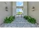 Landscaped pool entrance featuring stone pavers and sconce lighting at 10309 Longmeadow Ave, Parrish, FL 34219