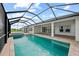 Inviting screened-in pool with a spillover spa, brick pavers, and a picturesque backyard view at 10309 Longmeadow Ave, Parrish, FL 34219