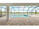 This brick-paved lanai offers a serene pool and spa experience with a picturesque waterfront view at 10309 Longmeadow Ave, Parrish, FL 34219