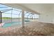 A spacious screened lanai with brick pavers includes a pool and spa with a tranquil lake view at 10309 Longmeadow Ave, Parrish, FL 34219
