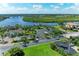Aerial view showcasing a waterfront area with a bridge, lush greenery, and surrounding residences at 11915 Oak Ridge Dr, Parrish, FL 34219