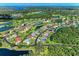 Expansive aerial view of a community featuring diverse homes nestled around ponds and winding roads at 11915 Oak Ridge Dr, Parrish, FL 34219