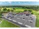 Stunning aerial of the clubhouse featuring ample parking and easy access to the scenic golf course and other amenities at 11915 Oak Ridge Dr, Parrish, FL 34219