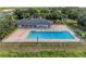 Aerial view of an outdoor swimming pool with lounge chairs, surrounded by a fence at 11915 Oak Ridge Dr, Parrish, FL 34219