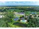 Gorgeous aerial view of the community, highlighting the golf course, tennis courts, pool, clubhouse and surrounding nature at 11915 Oak Ridge Dr, Parrish, FL 34219