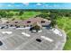 Aerial shot showcasing the clubhouse and parking lot, adjacent to a meticulously maintained golf course at 11915 Oak Ridge Dr, Parrish, FL 34219
