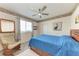 This bedroom features a bed, ceiling fan, and a window for natural light at 11915 Oak Ridge Dr, Parrish, FL 34219