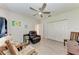 This bedroom features a comfortable leather chair, ceiling fan, and plank flooring at 11915 Oak Ridge Dr, Parrish, FL 34219