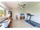 This bedroom features a desk, TV, ceiling fan, and a treadmill for exercise and comfort at 11915 Oak Ridge Dr, Parrish, FL 34219
