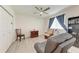 This bedroom features a comfortable leather chair, ceiling fan, and plank flooring at 11915 Oak Ridge Dr, Parrish, FL 34219