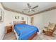This bedroom features a bed, ceiling fan, and a window for natural light at 11915 Oak Ridge Dr, Parrish, FL 34219
