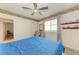 This bedroom features a bed, ceiling fan, and a window for natural light at 11915 Oak Ridge Dr, Parrish, FL 34219