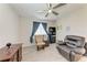 This bedroom features a comfortable leather chair, ceiling fan, and plank flooring at 11915 Oak Ridge Dr, Parrish, FL 34219