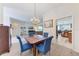 Bright dining room with hardwood floors, chandelier, and blue upholstered chairs at 11915 Oak Ridge Dr, Parrish, FL 34219