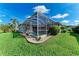 Well-maintained home exterior with screened-in pool, lush lawn and manicured landscaping at 11915 Oak Ridge Dr, Parrish, FL 34219