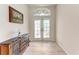 Welcoming foyer with tile flooring, decorative console table, and stylish stained glass transom window at 11915 Oak Ridge Dr, Parrish, FL 34219