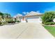 Attractive single-story residence featuring a spacious driveway, manicured landscaping, and a three-car garage at 11915 Oak Ridge Dr, Parrish, FL 34219