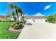 Inviting single-Gathering home with a spacious driveway, lush greenery, and a three-car garage at 11915 Oak Ridge Dr, Parrish, FL 34219