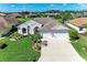 Charming single-story home with a well-manicured lawn and three-car garage at 11915 Oak Ridge Dr, Parrish, FL 34219