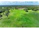 Scenic view of lush golf course offering challenging play and serene surroundings, creating an ideal golfer's paradise at 11915 Oak Ridge Dr, Parrish, FL 34219