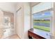 Hallway featuring serene lake views from the window, plus access to a bathroom at 11915 Oak Ridge Dr, Parrish, FL 34219