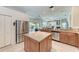 Modern kitchen with stainless steel appliances and a view of the lanai and pool at 11915 Oak Ridge Dr, Parrish, FL 34219