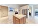 Granite-topped kitchen island with wood cabinets and view of the dining and living areas at 11915 Oak Ridge Dr, Parrish, FL 34219