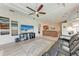 Open-concept living room with a large TV and neutral toned furniture at 11915 Oak Ridge Dr, Parrish, FL 34219