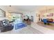 Bright living space with tile flooring, comfortable furnishings, and sliding glass doors to the outdoors at 11915 Oak Ridge Dr, Parrish, FL 34219