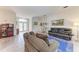 Open-concept living area featuring tile floors, comfortable seating, and lots of natural light at 11915 Oak Ridge Dr, Parrish, FL 34219