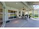 Covered patio with seating area and sliding doors that offers view of a refreshing pool at 11915 Oak Ridge Dr, Parrish, FL 34219