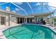 Refreshing screened pool with clear water, surrounded by a patio and manicured backyard at 11915 Oak Ridge Dr, Parrish, FL 34219
