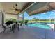 Inviting screened-in pool area with clear water, outdoor seating and fan for relaxing poolside at 11915 Oak Ridge Dr, Parrish, FL 34219