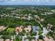 Expansive aerial view of a luxury home showcasing its lush landscaping and prime location within a beautiful residential community at 12448 Highfield Cir, Lakewood Ranch, FL 34202