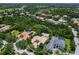 An overhead glimpse of a stunning property with mature trees, offering privacy and nestled in a neighborhood with perfectly manicured lawns at 12448 Highfield Cir, Lakewood Ranch, FL 34202