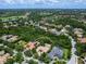 Bird's-eye view of the property displaying its tile roof, lush greenery, and privileged setting in a well-established residential area at 12448 Highfield Cir, Lakewood Ranch, FL 34202