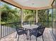 Balcony featuring a table and seating with views of the beautiful tropical landscape at 12448 Highfield Cir, Lakewood Ranch, FL 34202