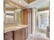 Elegant bathroom with granite countertop, wooden cabinets, and a framed mirror, offering a luxurious feel at 12448 Highfield Cir, Lakewood Ranch, FL 34202