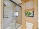 This bathroom includes a glass shower door, a small window providing natural light, and a modern toilet at 12448 Highfield Cir, Lakewood Ranch, FL 34202