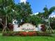A beautifully landscaped entrance sign for Highfield community with lush greenery and vibrant flowers at 12448 Highfield Cir, Lakewood Ranch, FL 34202