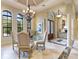 Dining room featuring coffered ceiling, arched windows, chandelier, and open access to the entryway at 12448 Highfield Cir, Lakewood Ranch, FL 34202