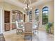 Elegant dining room featuring a chandelier, custom built-in cabinets, and natural light at 12448 Highfield Cir, Lakewood Ranch, FL 34202